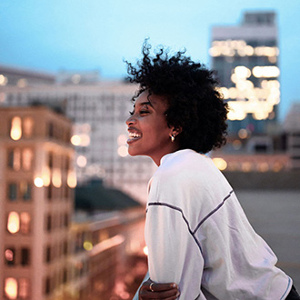 Smiling woman in front of city skyline 