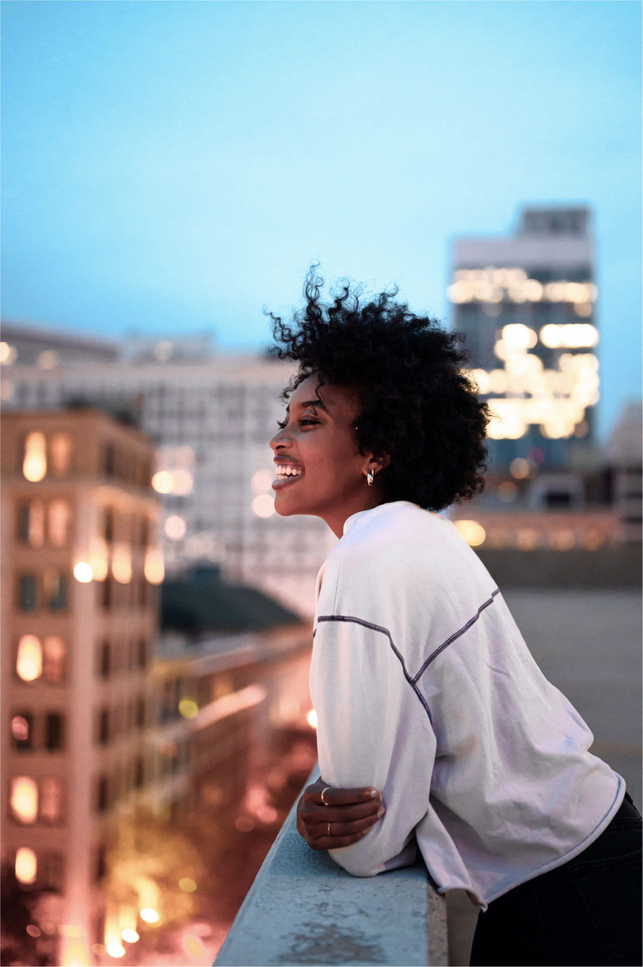 Woman in front of a city skyline 